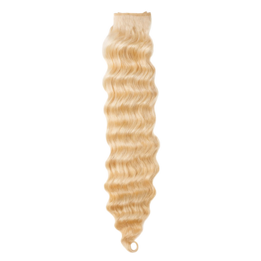 A bundle of natural blonde loose wave hair extensions.